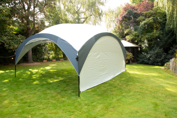 Fastpitch Shelter Sunwall with Door set up in a garden.