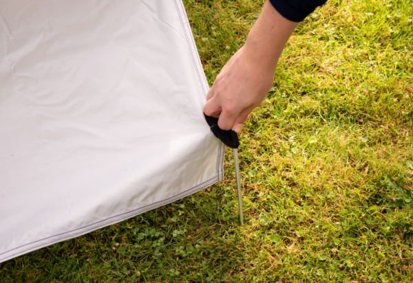 Fastpitch Shelter Sunwall with Door pegs in the ground