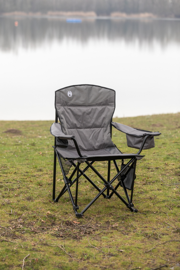 Coleman Maximus Sling Steel Chair set up in front of a river bank