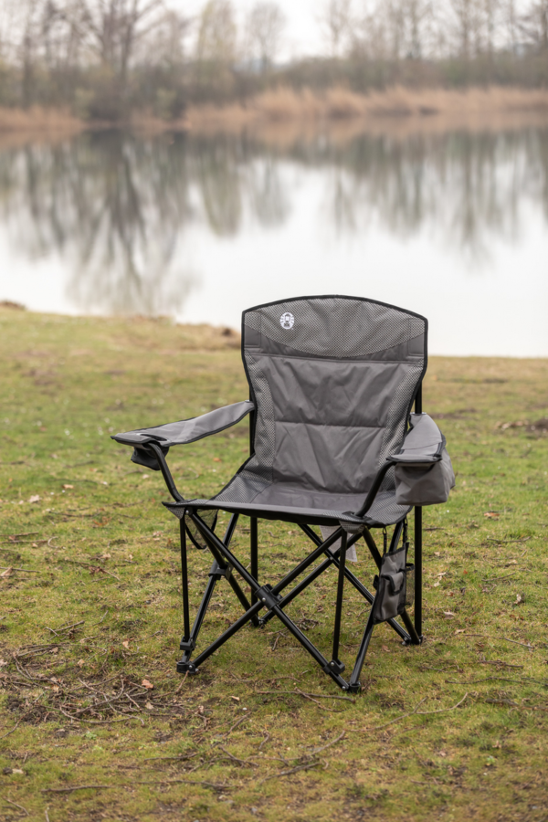 Coleman Maximus Sling Steel Chair set up in front of a river bank