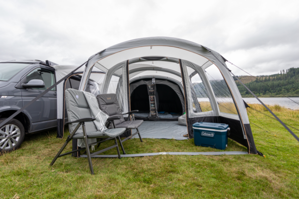 Coleman Recliner Chairs set up at the entrance of a tent at the campsite