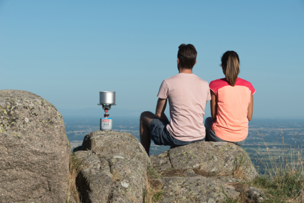 Fyrestorm Stove fired up on top of a mountain by a couple outdoors